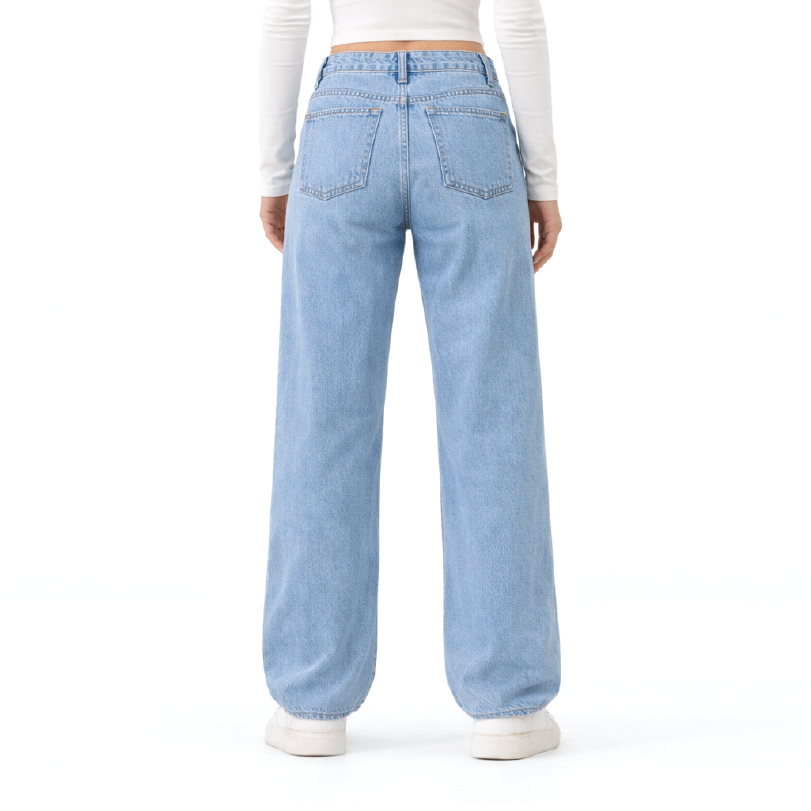 A person shown from the back wearing light-wash wide-leg denim jeans, a white long-sleeve crop top, and white sneakers against a plain white studio background.