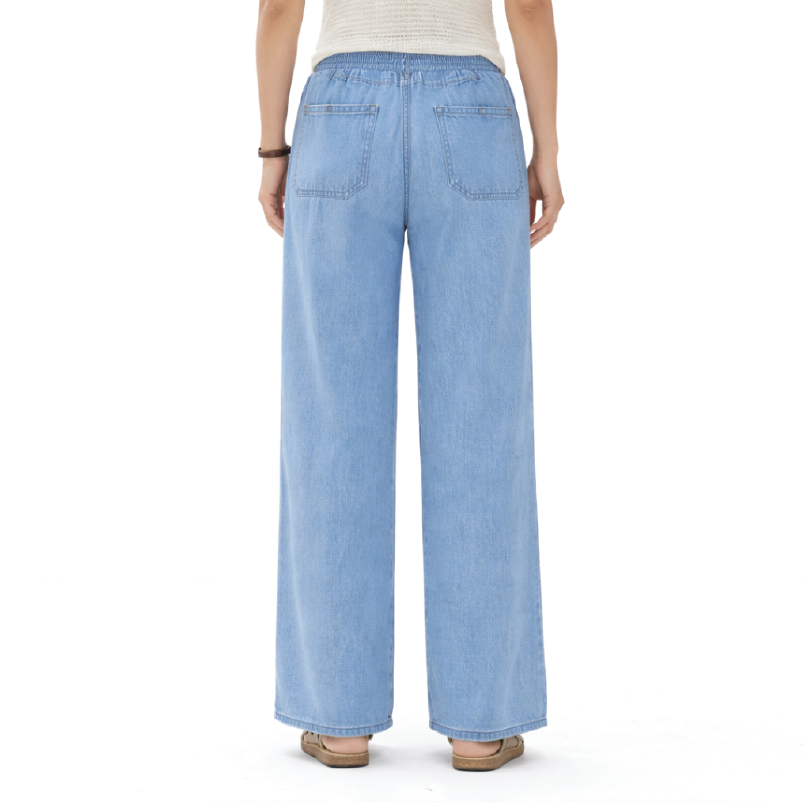 A person shown from the back wearing light blue wide-leg denim jeans, a light beige top, and brown flat sandals against a plain white background.
